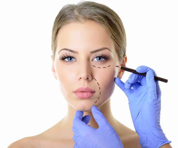 Beautiful woman ready for cosmetic surgery, female face with doctor's hands with pencil, over white